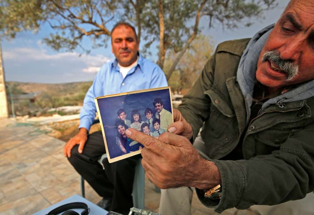 The uncle of Rashida Tlaib, the winner of Michigan's 13th congressional district in the 2018 US general election, displays a picture of her in the village of Bayt Or al Fawqa, in the occupied West Bank on November 8, 2018.  AFP / Abbas Momani