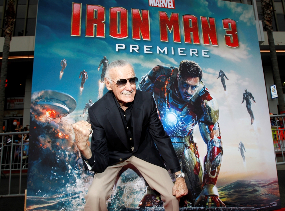 Stan Lee gestures as he poses at the premiere of 