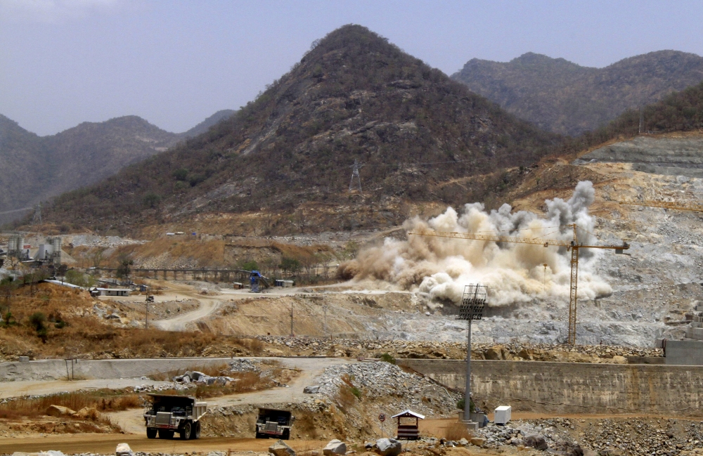 A cloud of dust rises from a dynamite blast, as part of construction work at Ethiopia's Grand Renaissance Dam, March 31, 2015. Reuters/Tiksa Negeri