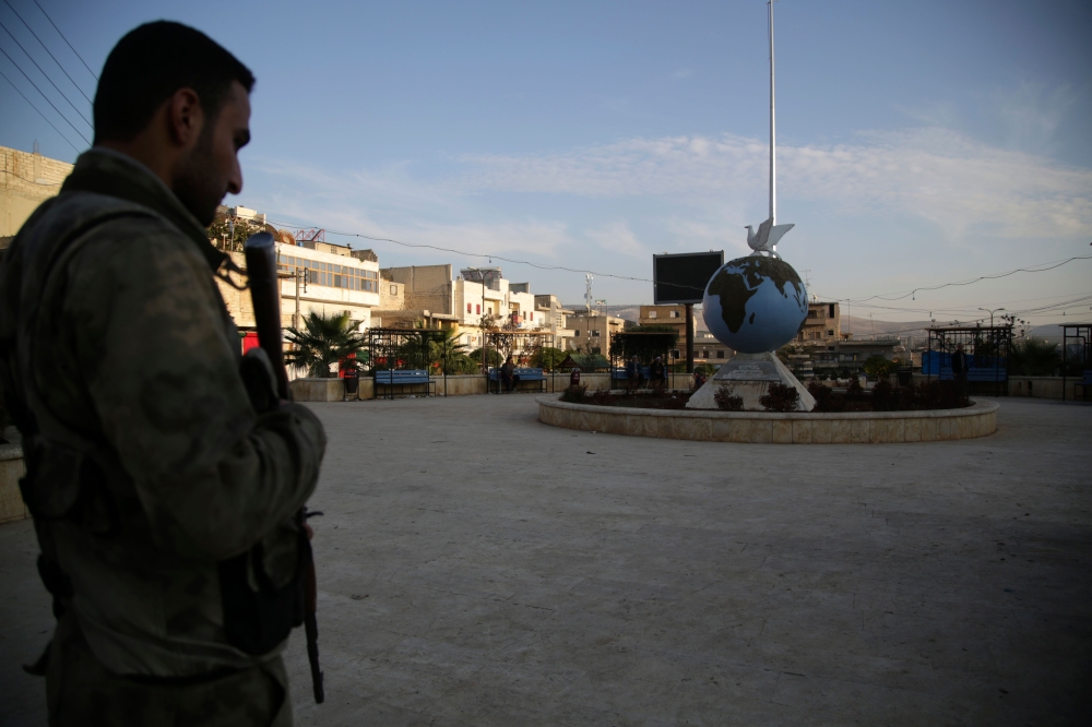 A Turkey-backed Syrian fighter stands guard on November 19, 2018 in the northwestern Syrian city of Afrin.  AFP / Bakr ALKASEM