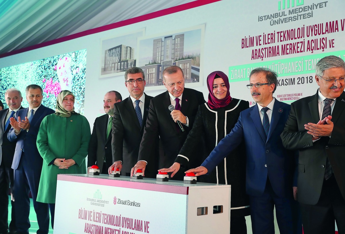 President Recep Tayyip Erdogan (4th R) presses a button during the opening ceremony of the Istanbul Medeniyet University Science and Advanced Technology Application and Research Center and also groundbreaking ceremony of the Ziraat Bank Library in Istanbu