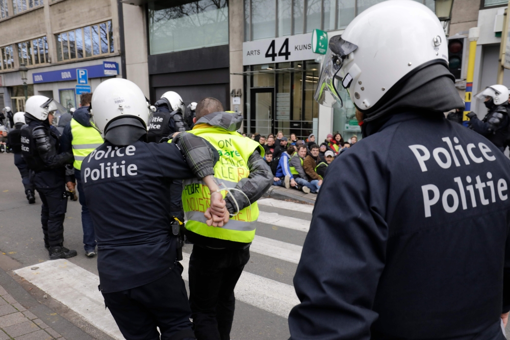 Policemen arrest protestors during a copycat 
