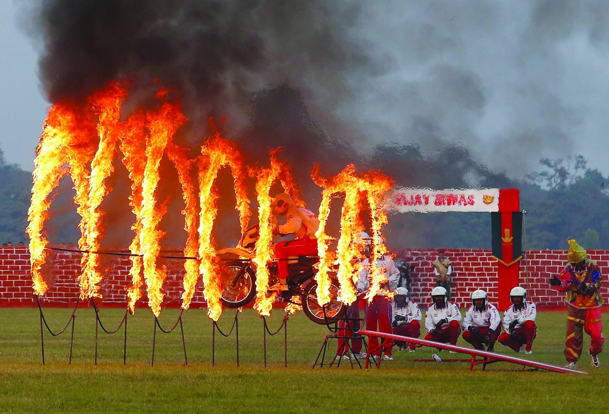 An Indian army soldier performs a stunt during celebrations ahead of the 