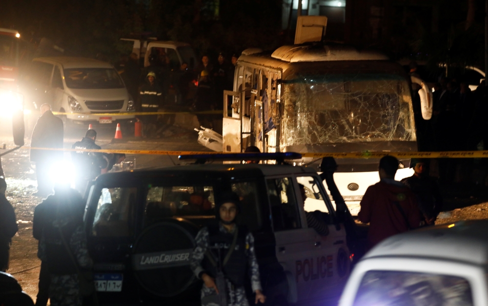 Police officers inspect a scene of a bus blast in Giza, Egypt, December 28, 2018. (REUTERS/Amr Abdallah Dalsh)