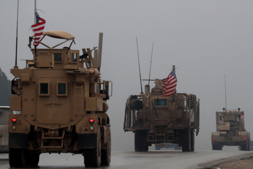 (FILES) In this file photo taken on December 30, 2018, shows a line of US military vehicles in Syria's northern city of Manbij. AFP / Delil SOULEIMAN