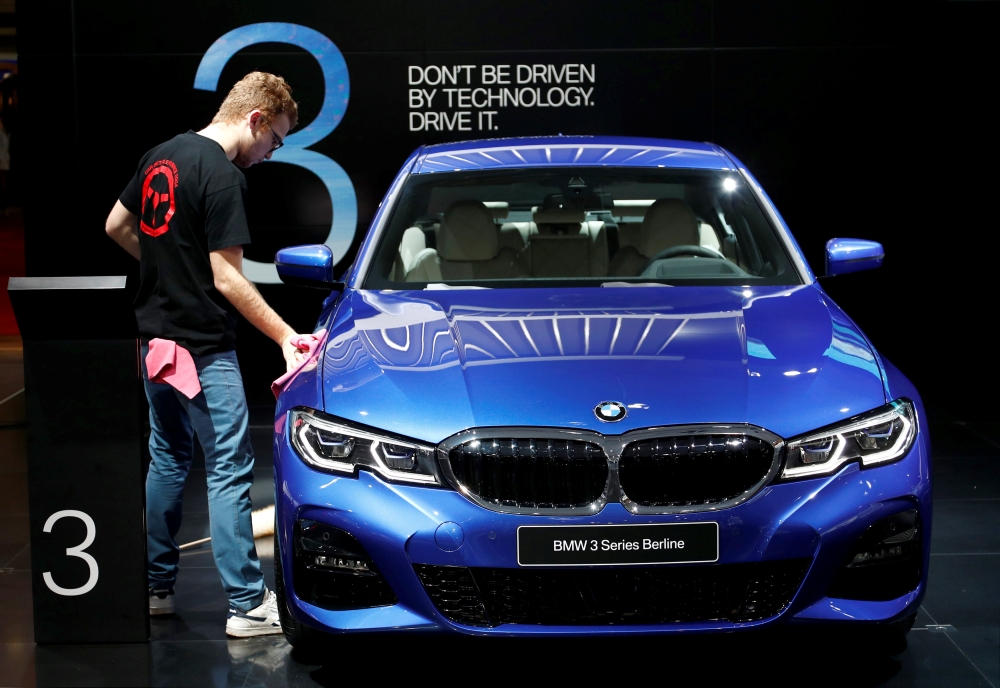 A worker cleans a BMW 3-Series car at Brussels Motor Show, Belgium, January 18, 2019. Reuters/Francois Lenoir
 