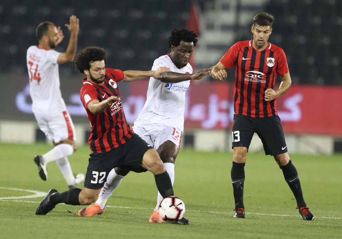 Al Rayyan’s Ahmad Mohamed Al Sayyid (second left) vies for the ball with Al Arabi’s Wilfried Bony during their QNB Stars League match played at the Al Sadd Stadium, yesterday.