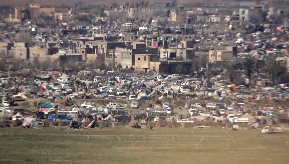 A view of people moving between tents in a makeshift camp in the last Islamic State (IS) group-controlled piece of territory in Syria's Baghouz in the eastern Deir Ezzor province.  AFP / Free Burma Rangers