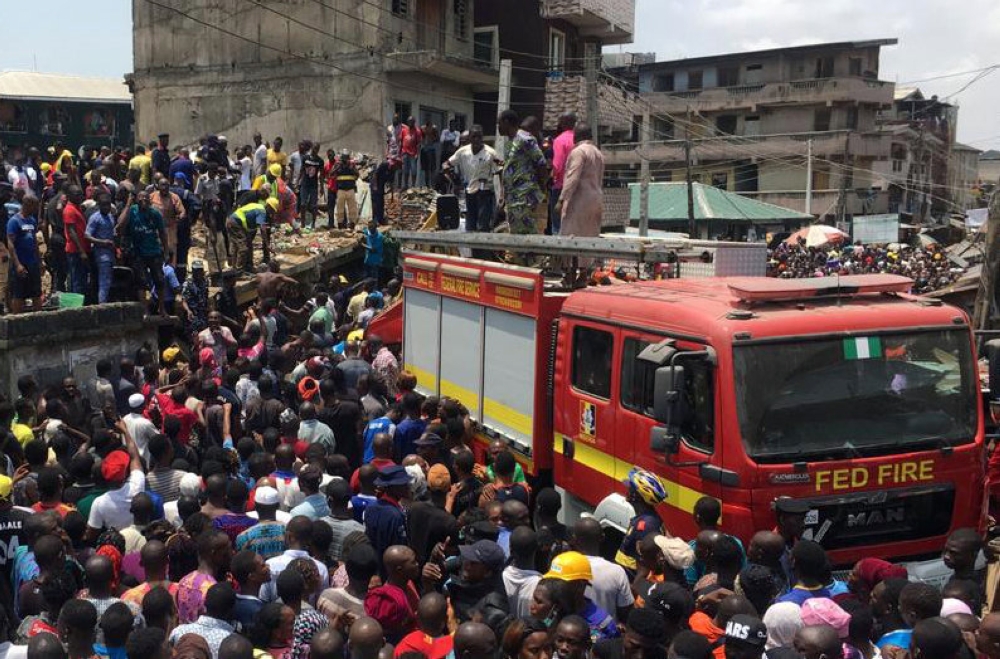 Rescue workers are seen at the site of a collapsed building containing a school in Nigeria's commercial capital of Lagos, Nigeria March 13, 2019. REUTERS/Temilade Adelaja