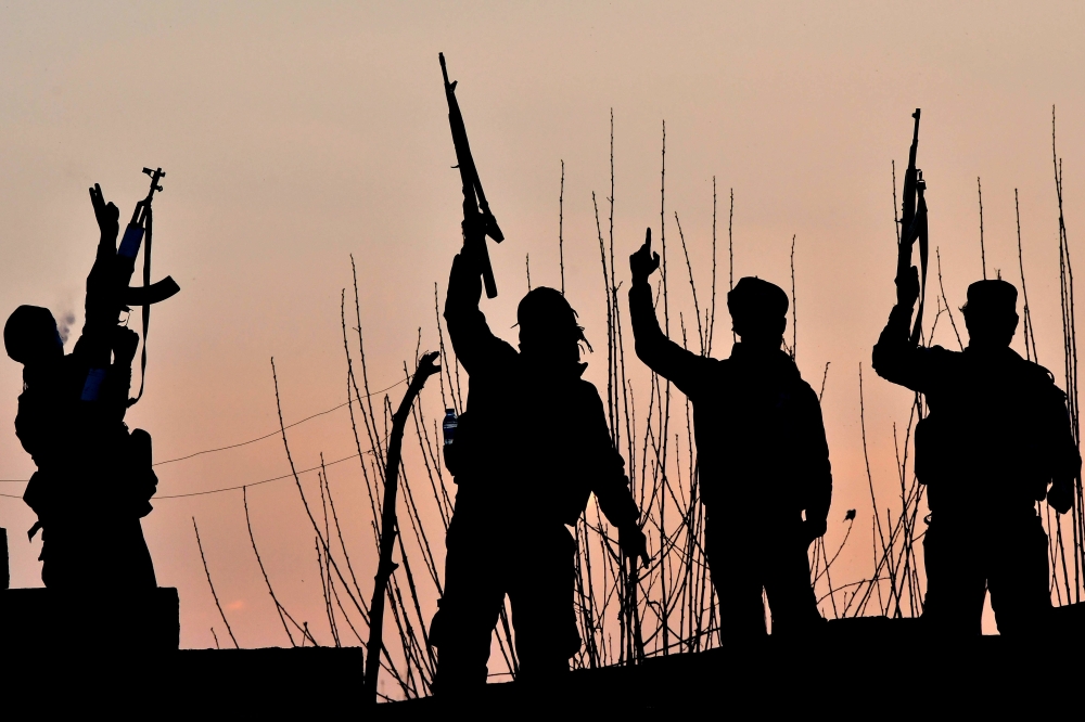 US-backed Syrian Democratic Forces (SDF) fighters celebrate after fighting Islamic State (IS) group jihadists near the village of Baghouz in the eastern Syrian province of Deir Ezzor, on March 15, 2019. AFP / GIUSEPPE CACACE