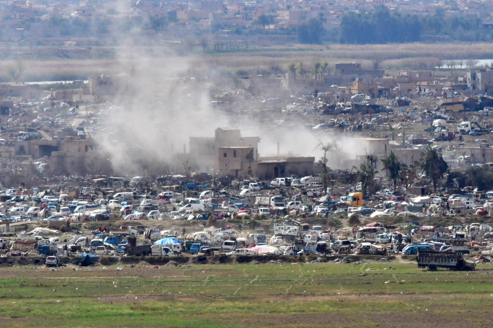 A view overlooking the camp of Baghouz where remaining Islamic State (IS) group fighters and their families are holding out in the last position controlled by IS as Syrian Democratic Forces' (SDF) fighters await to advance on them, in the countryside of t