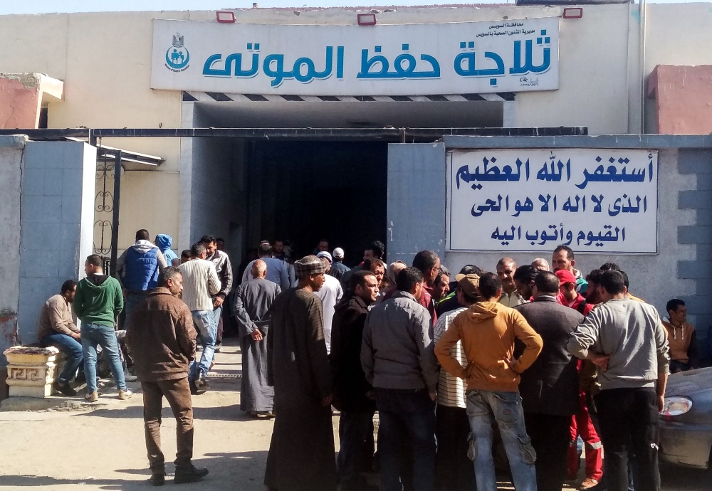 Family-members and relatives of the victims of an explosion at a chemical plant gather outside a morgue to receive their bodies, in the Egyptian Red Sea port city of Suez on March 21, 2019. AFP