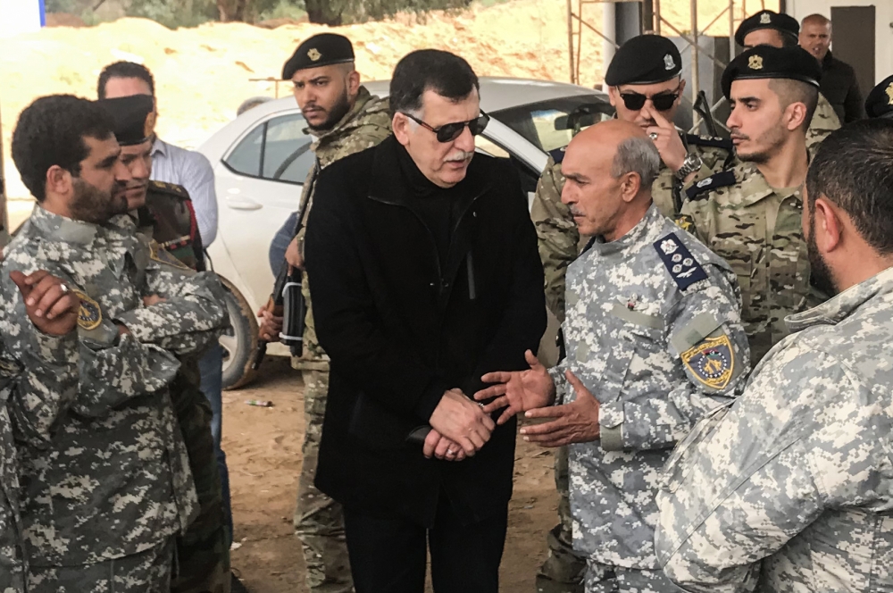 The head of Libya's UN-backed unity government, Fayez al-Sarraj (C), visits military and security commanders of the government forces who supervised recapture of the checkpoint 27 in Janzour, between Tripoli and the coastal town of Zawiya on April 5, 2019