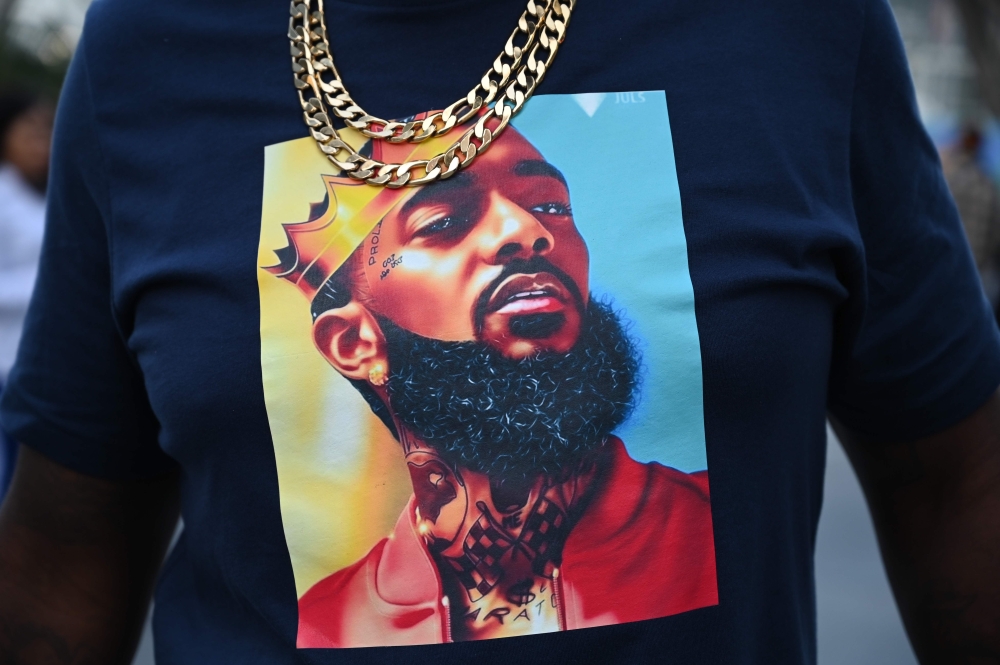 People arrive to attend the Celebration of Life memorial service for rapper recording artist and social activist Nipsey Hussle, April 11, 2019 at the Staples Center in Los Angeles, California.  AFP / Robyn Beck 