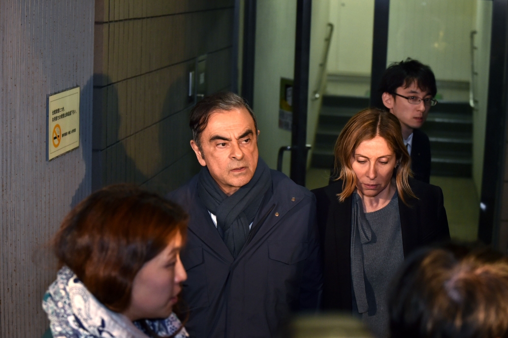 (FILES) In this file photo taken on April 3, 2019, former Nissan Chairman Carlos Ghosn (2nd L) and his wife Carole (2nd R) leave the office of his lawyer in Tokyo. AFP / Kazuhiro Nogi 