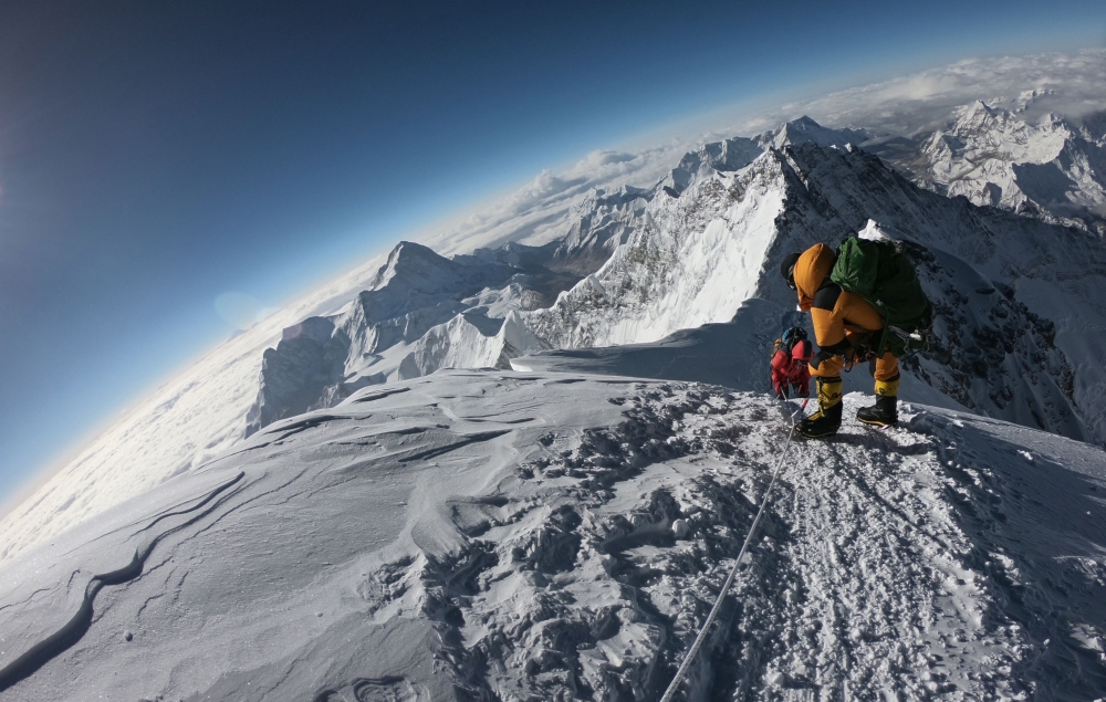 (FILES) In this file photo taken on May 17, 2018, mountaineers make their way to the summit of Mount Everest, as they ascend on the south face from Nepal. AFP / Phunjo Lama 