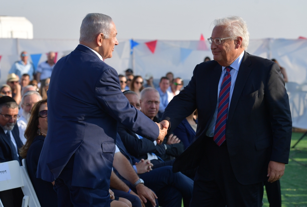 Israeli Prime Minister Benjamin Netanyahu (L) and U.S. Ambassador to Israel David Friedman (R) attend a groundbreaking of a Jewish settlement named 
