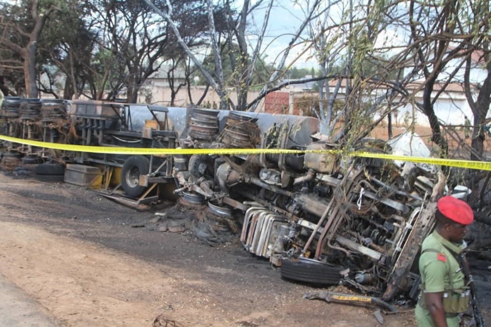 Police tape cordons off the area where the carcass of a burnt-out fuel tanker is seen along the side of the road following an explosion on August 10, 2019, in Morogoro, 200 kilometres (120 miles) west of the Tanzanian capital Dar es Salaam.  AFP / STRINGE