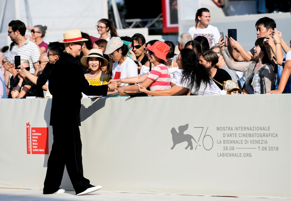 Director Yonfan signs autographs at the 76th Venice Film Festival, September 2, 2019. Reuters/Piroschka van de Wouw