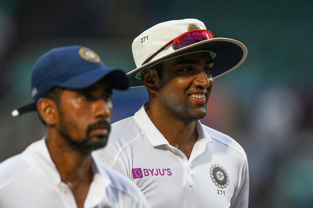 India's Ravichandran Ashwin (R) leaves the ground after taking 5 wickets in their innings during the third day's play of the first Test match between India and South Africa at the Dr. Y.S. Rajasekhara Reddy ACA-VDCA Cricket Stadium in Visakhapatnam on Oct
