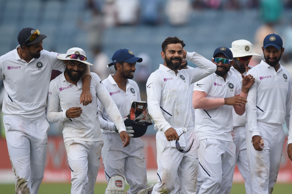 Indian team captain Virat Kohli (C) celebrates with teammates on the fourth day of play after winning the second Test cricket match against South Africa, at the Maharashtra Cricket Association Stadium in Pune on October 13, 2019. AFP / PUNIT PARANJPE 