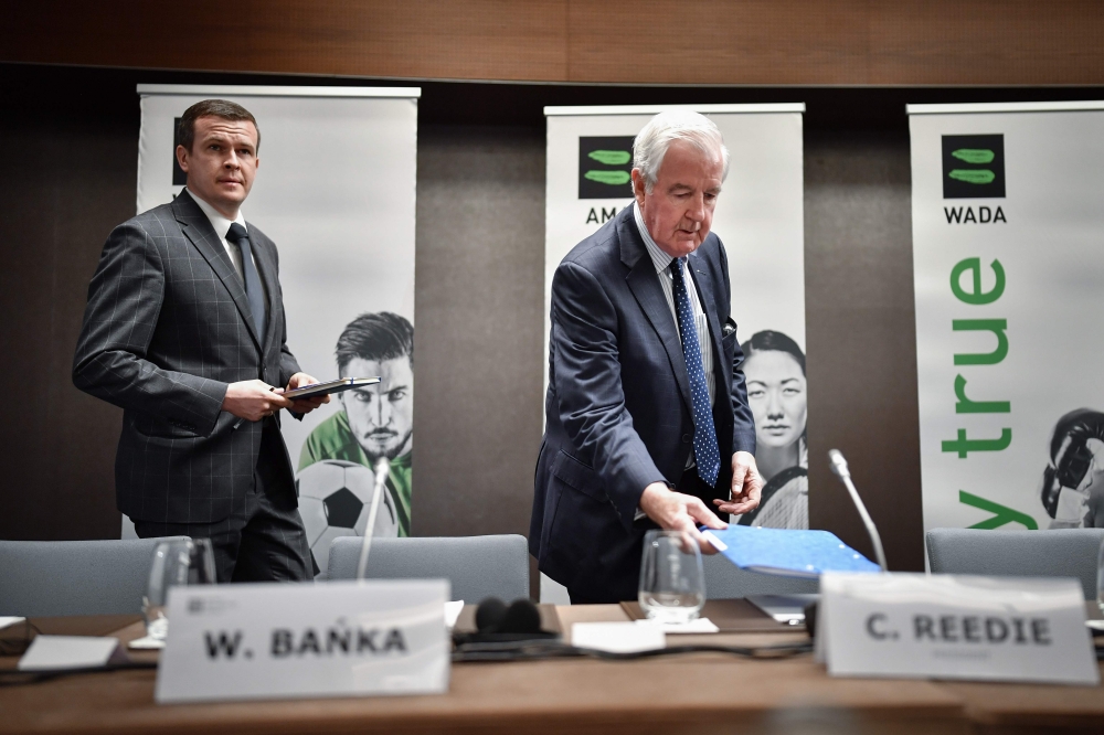 World Anti-Doping Agency (WADA) President Craig Reedie (R) followed by WADA President-Elect Witold Banka arrives to a press conference following a meeting of the WADA executive committee on Russian ban on December 9, 2019 in Lausanne. AFP / Fabrice Coffri