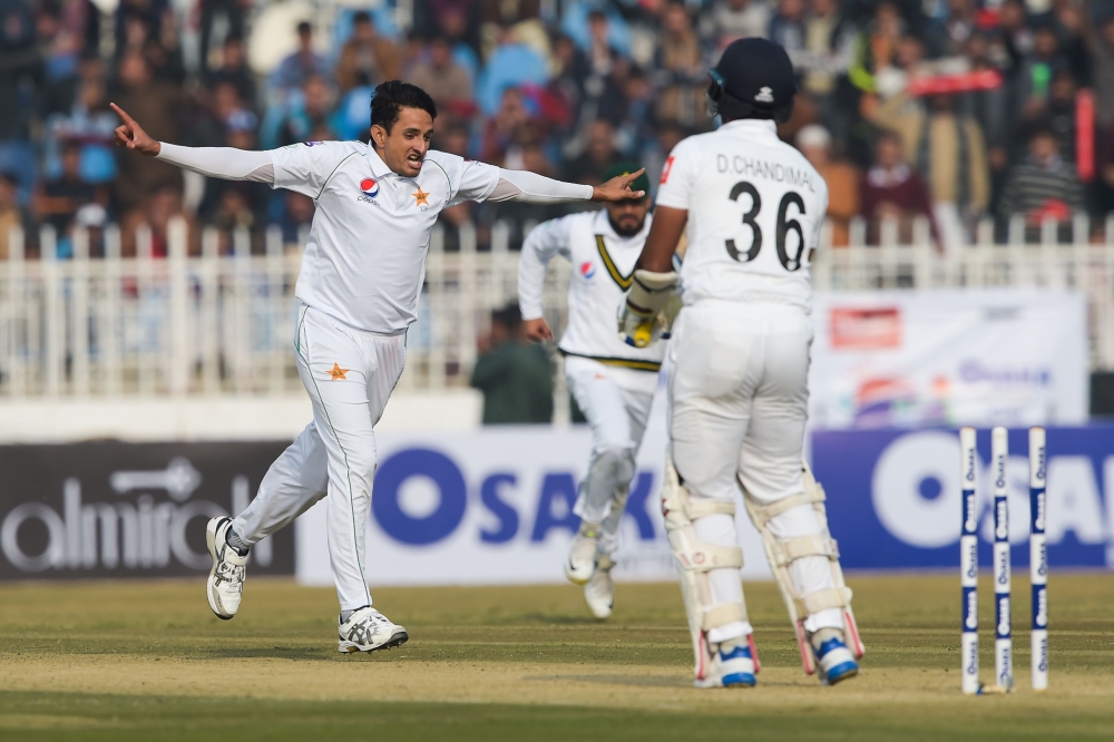 Pakistan's Mohammad Abbas (L) celebrates after bowing out Sri Lanka's Dinesh Chandimal (R) Pakistan's Mohammad Abbas celebrates the dismissal of Sri Lanka's Dinesh Chandimal during the first day of the first Test cricket match between Pakistan and Sri Lan
