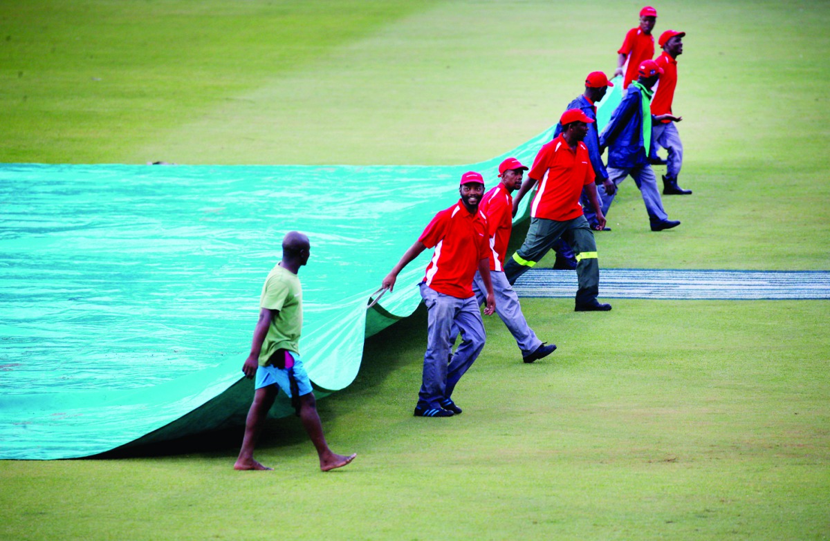 Groundsman at the Kingsmead Cricket Ground covering the pitch area during the South Africa vs England, second ODI, yesterday.