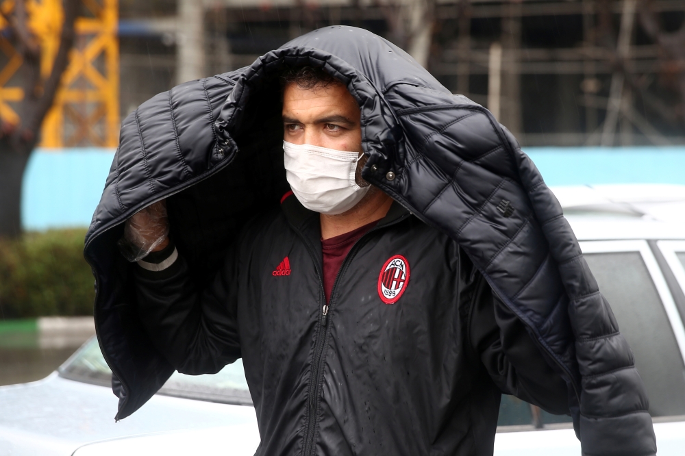 An Iranian man wears protective mask to prevent contracting coronavirus, as he walks in the street in Tehran, Iran February 25, 2020. 
