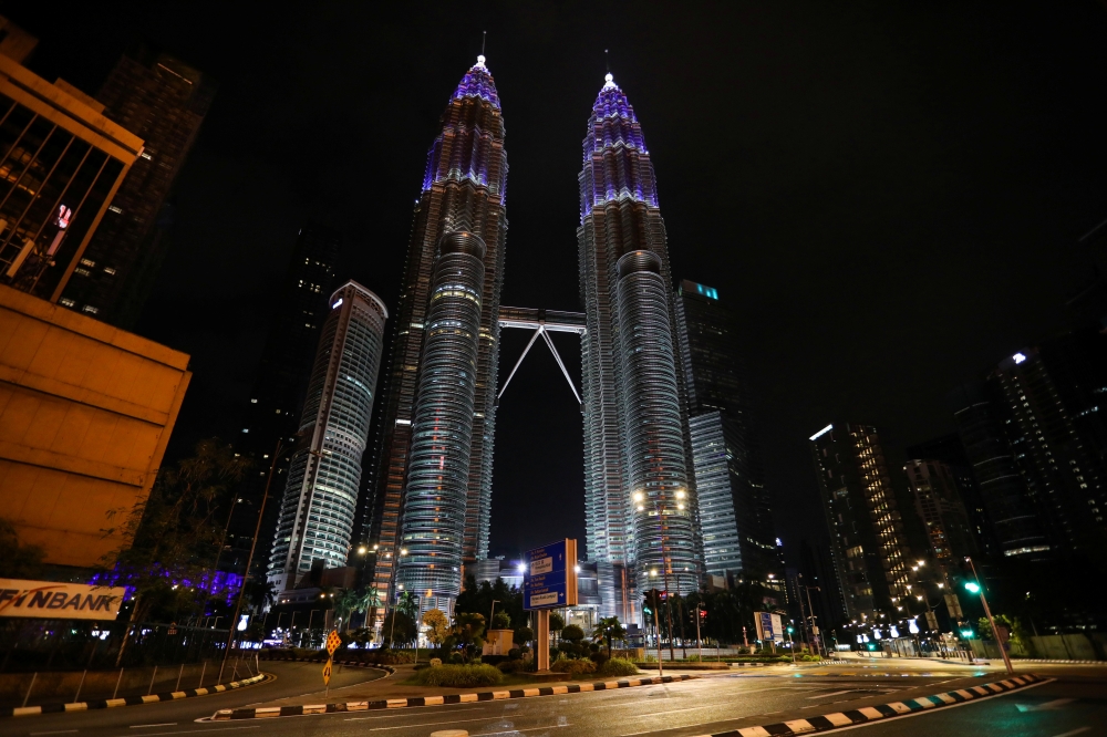 Petronas Twin Towers are seen illuminated in blue as part of the 