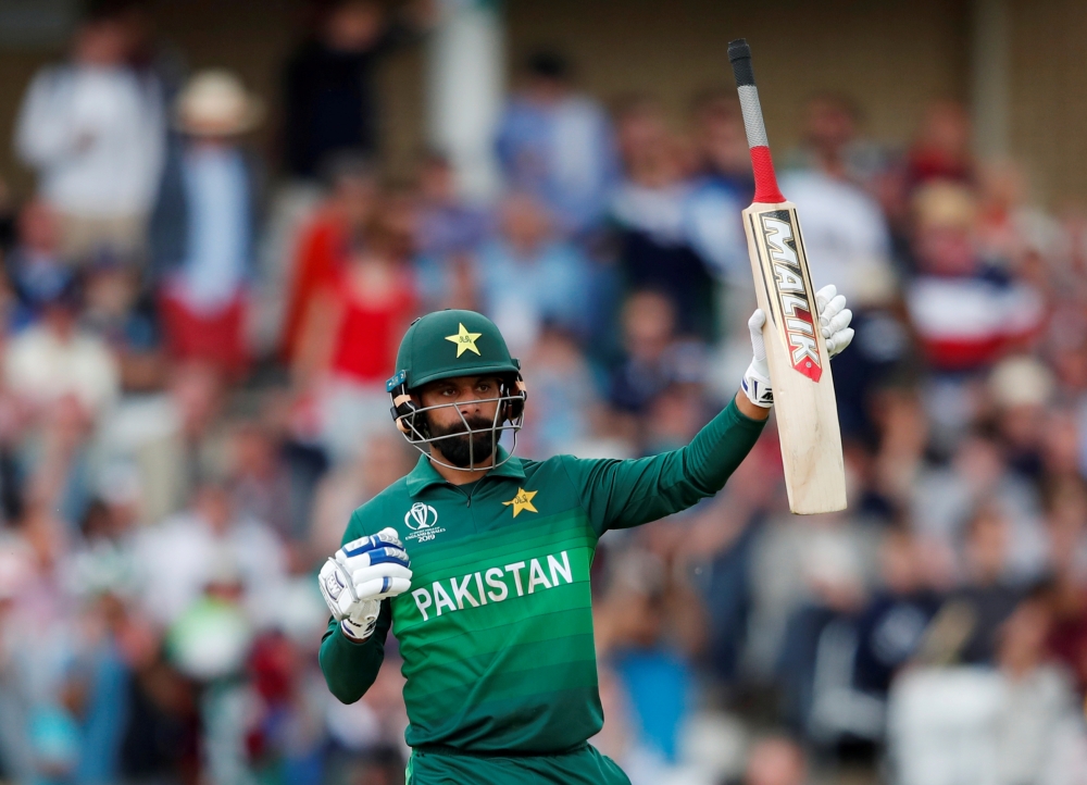FILE PHOTO: England v Pakistan - June 3, 2019 Pakistan's Mohammad Hafeez celebrates a half century Action Images via Reuters/Andrew Boyers/File Photo