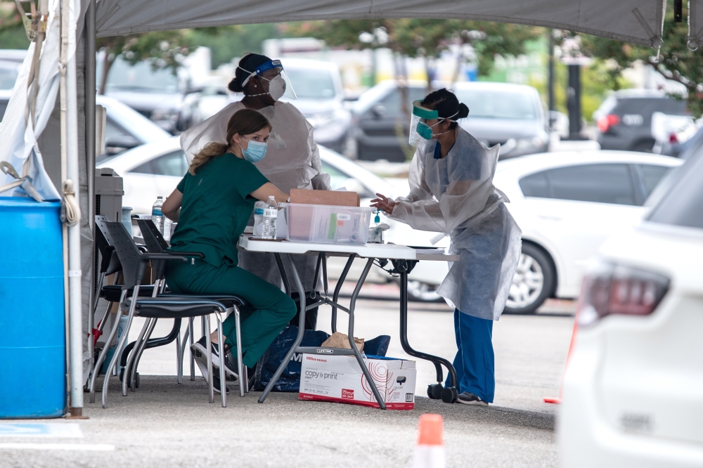 Medical personnel work at a COVID-19 testing center on July 7, 2020 in Austin, Texas. Sergio Flores/Getty Images/AFP