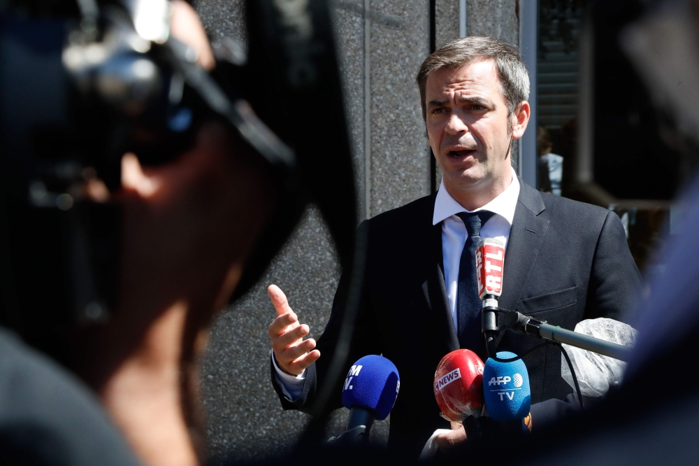 French Health Minister Olivier Veran speaks to the press after visitng French postal service 