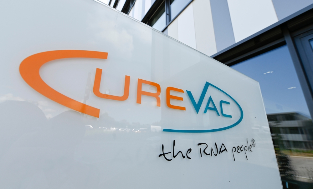 In this file photo taken on June 23, 2020 the logo of the biopharmaceutical company CureVac is seen in front of the company's headquarters in Tuebingen, southern Germany on June 23, 2020. / AFP / THOMAS KIENZLE