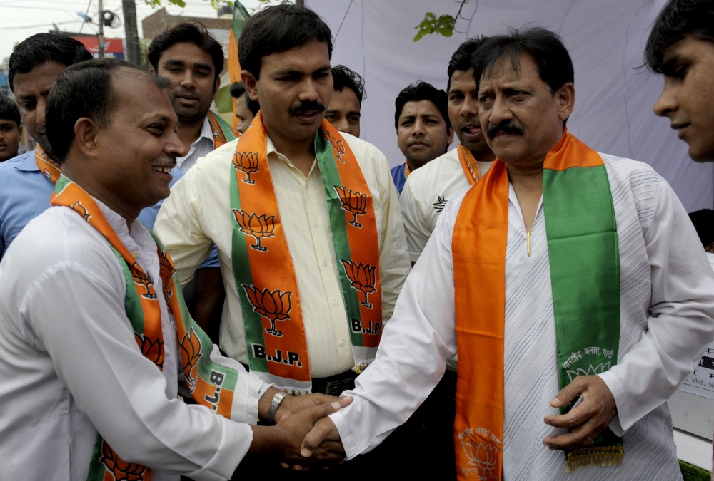 In this file photo taken on April 06, 2009 former Indian cricketer and Bharatiya Janta Party (BJP) candidate from east Delhi Chetan Chauhan (R) shakes hands with party workers as he campaigns for the forthcoming general elections in New Delhi. India's for