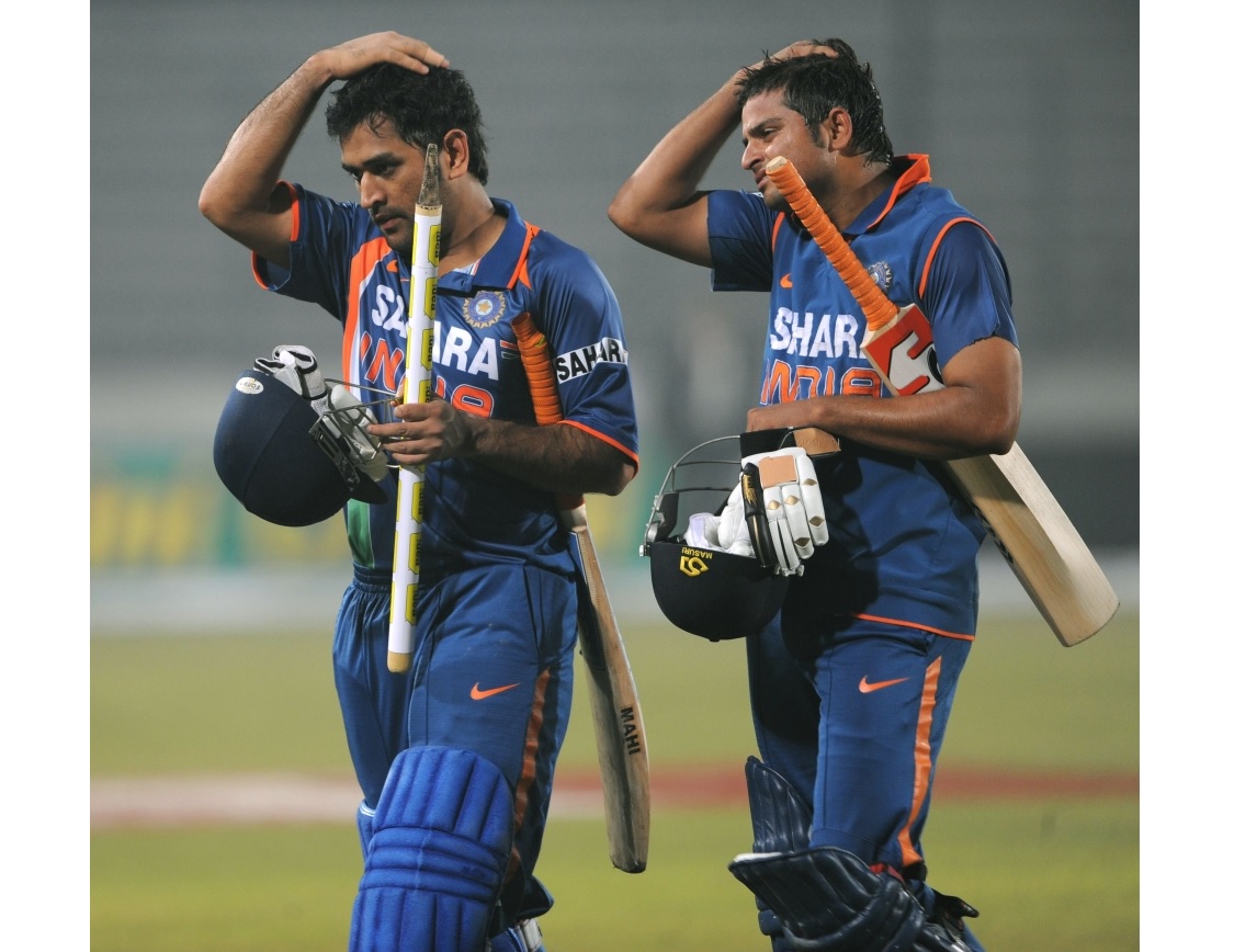 (FILES) In this file photo taken on January 8, 2010, Indian cricket team captain Mahendra Singh Dhoni (L) and teammate Suresh Raina walk off the pitch after victory in the Tri-Nation tournament cricket match between Bangladesh and India at The Sher-e Bang