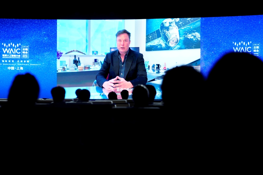 Tesla Inc Chief Executive Officer Elon Musk is seen on a screen during a video message at the opening ceremony of the World Artificial Intelligence Conference (WAIC) in Shanghai, China July 9, 2020. REUTERS/Aly Song/File Photo