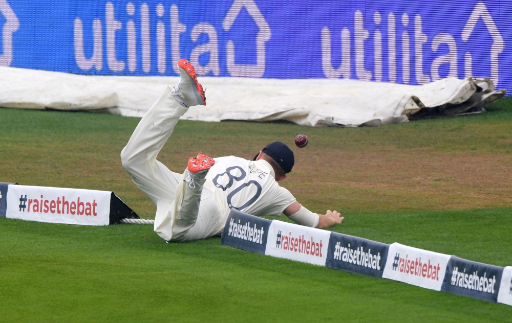 August 16, 2020 England's Ollie Pope fails to stop a boundary hit by Pakistan's Mohammad Rizwan. Stu Forster/Pool via REUTERS/File Photo