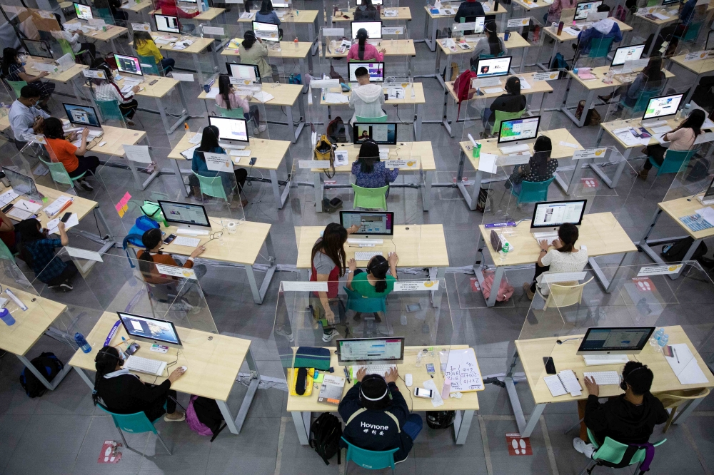Teachers answer calls and messages from students in need of assistance on distance learning through a hotline program, amid the coronavirus disease (COVID-19) outbreak, in Taguig City, Metro Manila, Philippines, October 7, 2020. Picture taken October 7, 2