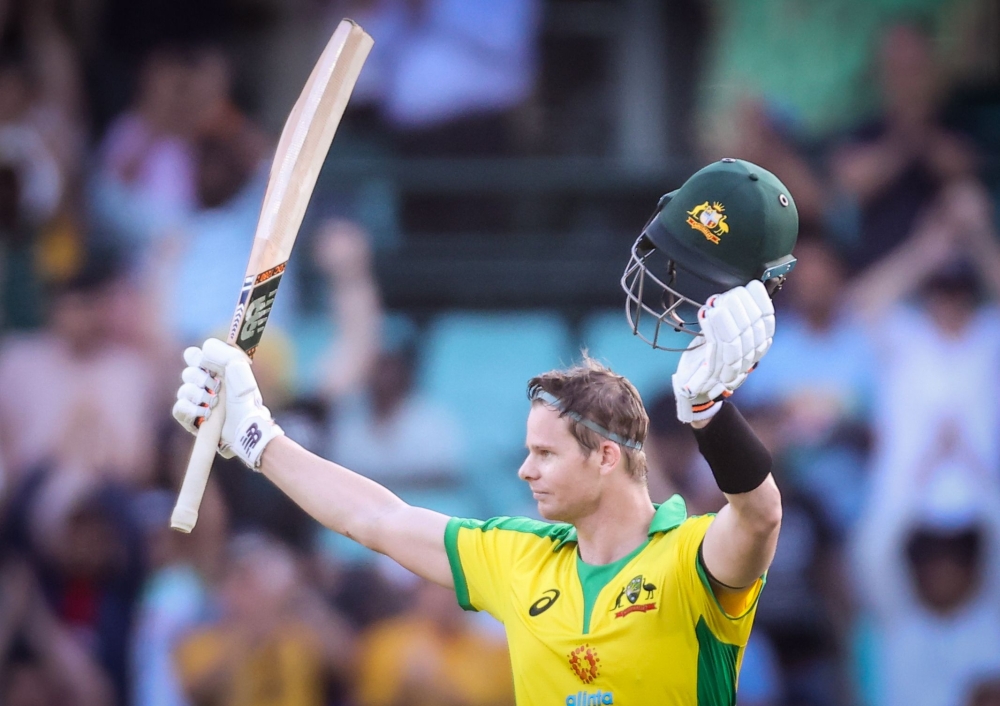 Australia’s Steve Smith celebrates reaching his century during the one-day international cricket match against India at the Sydney Cricket Ground (SCG) in Sydney on November 27, 2020. AFP / David Gray 