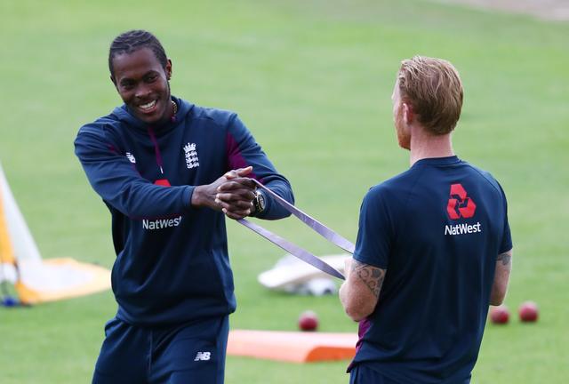 FILE PHOTO: Cricket - Third Test - England v West Indies - Emirates Old Trafford, Manchester, Britain - July 25, 2020 England's Jofra Archer and Ben Stokes warm up before the match, as play resumes behind closed doors following the outbreak of the coronav