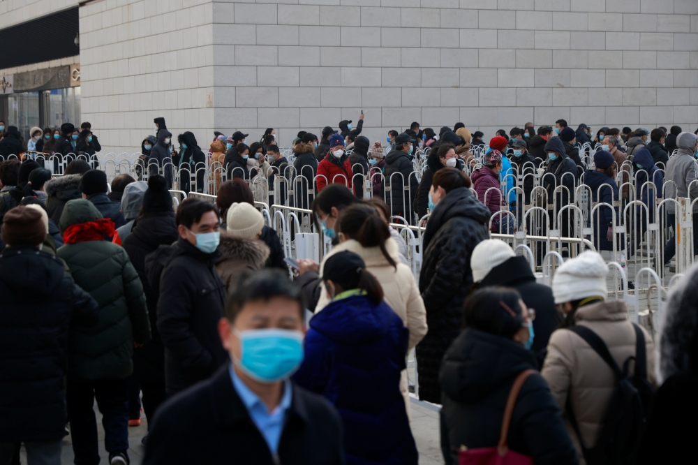 People line up to get their nucleic acid test at a mass testing site following the outbreak of the coronavirus disease (COVID-19) in Beijing, China, January 22, 2021. REUTERS/Thomas Peter
