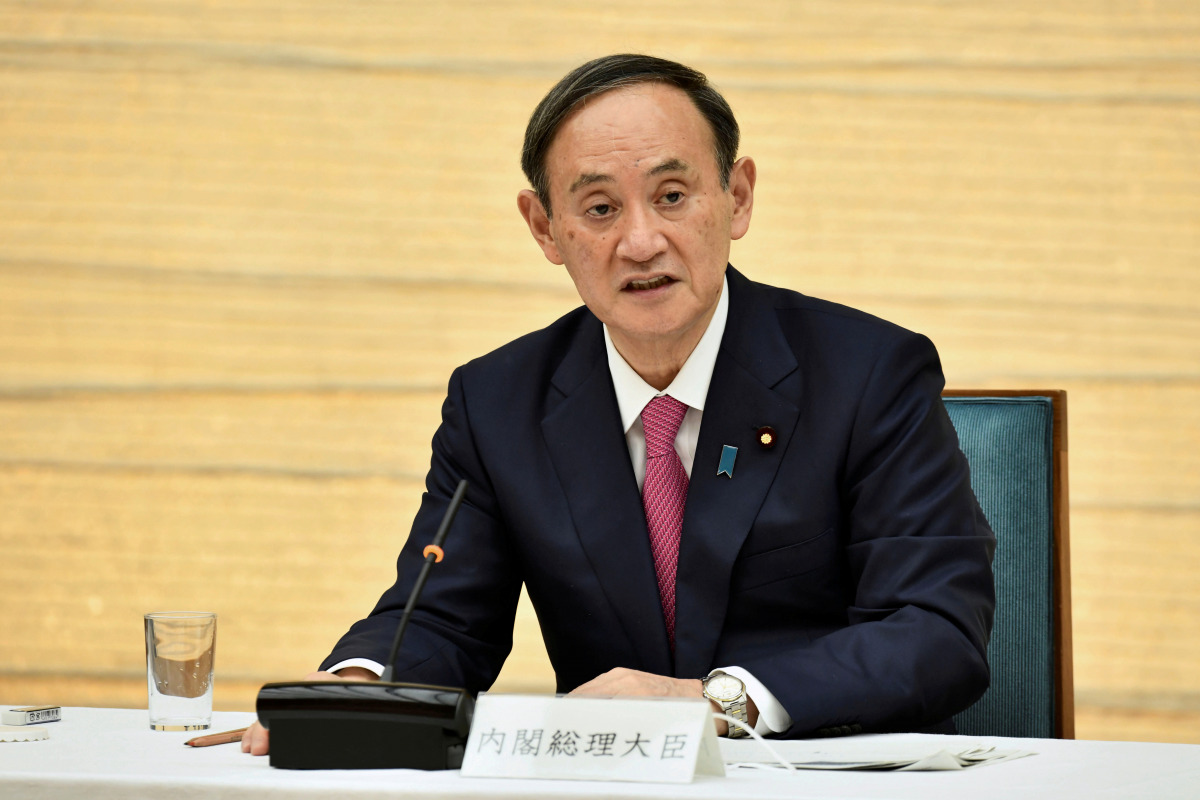 FILE PHOTO: Japanese Prime Minister Yoshihide Suga speaks during a meeting of the coronavirus disease (COVID-19) infection control headquarters at the prime minister's office in Tokyo, Japan January 22, 2021. Kazuhiro Nogi/Pool via REUTERS/File Photo
