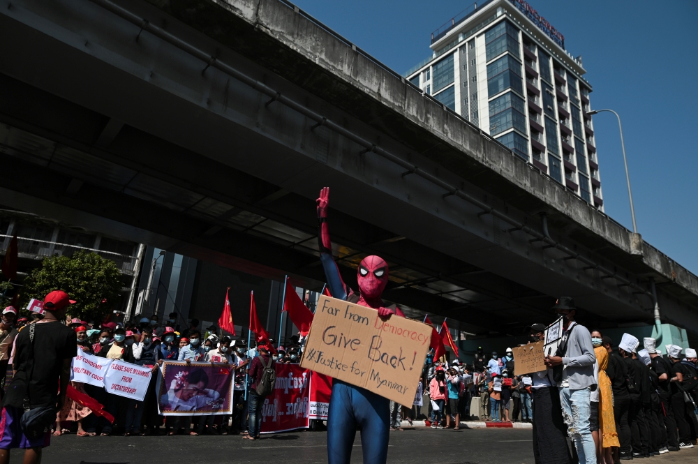 A protestor wearing a Spiderman costume gives the three-finger salute as he rallies against the military coup and to demand the release of elected leader Aung San Suu Kyi, in Yangon, Myanmar, February 10, 2021. REUTERS/Stringer