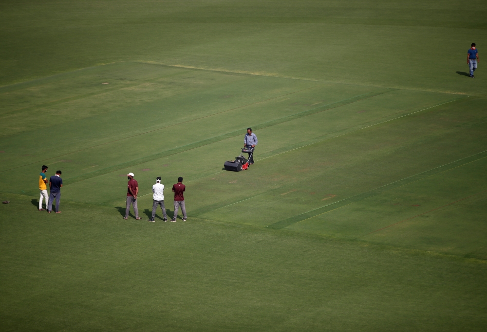 Groundsmen prepare a pitch at Sardar Patel Gujarat Stadium, where India and England are scheduled to play their third test match, in Ahmedabad, India, February 17, 2021. Reuters/Amit Dave