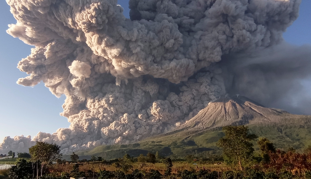 Mount Sinabung volcano erupts as seen from Kuta Rakyat village in Karo, North Sumatra Province, Indonesia March 2, 2021, in this photo taken by Antara Foto/Sastrawan Ginting/via Reuters