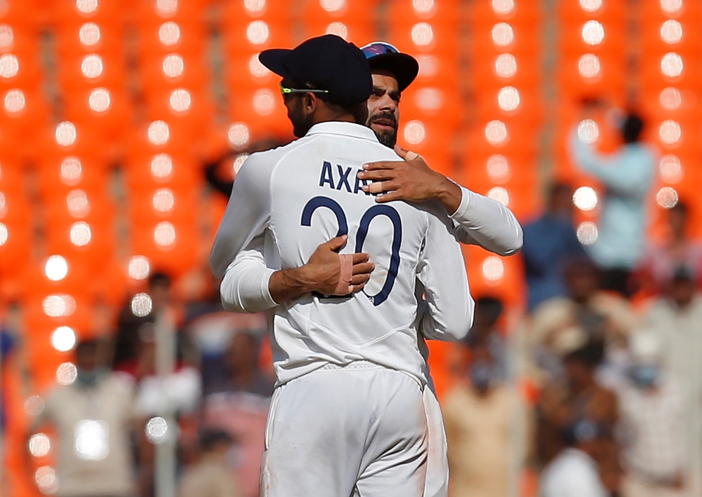 India's captain Virat Kohli hugs his teammate Axar Patel after they beat England. REUTERS/Amit Dave