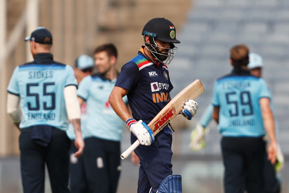 India's Virat Kohli walks off dejected after being bowled by England's Mark Wood and caught by Moeen Ali. Reuters/Francis Mascarenhas