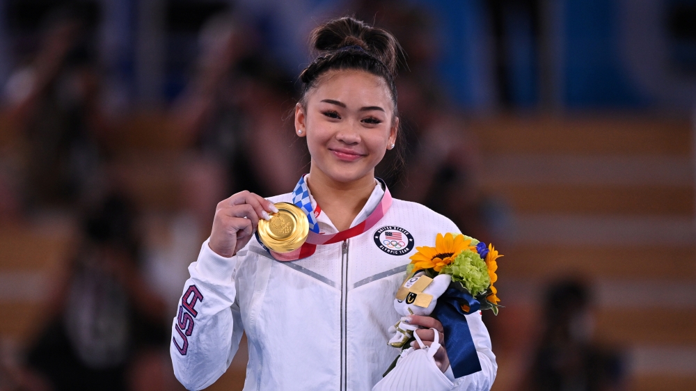Gold medallist Sunisa Lee of the United States poses on the podium. REUTERS/Dylan Martinez