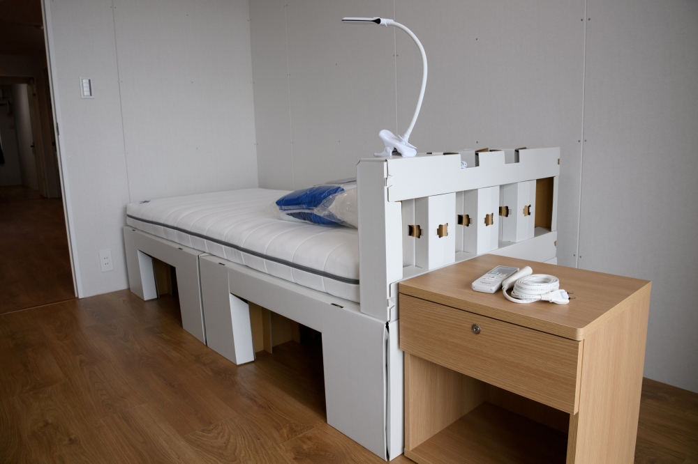 A recyclable cardboard bed and a mattress are pictured in a residential unit for athletes during a media tour at the Olympic and Paralympic Village for the Tokyo 2020 Games, in Tokyo, Japan June 20, 2021. Akio Kon/Pool via REUTERS/File Photo